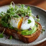 Toasted Izzio sourdough topped with avocado, poached egg, and microgreens