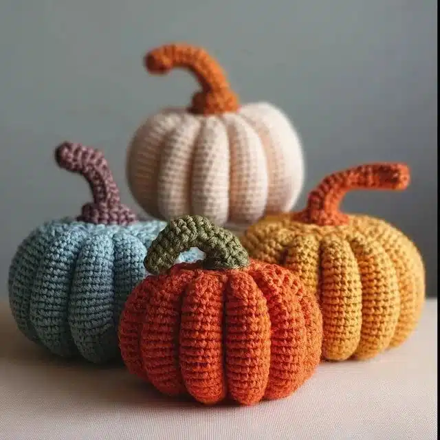 Handmade crochet pumpkin in autumn colors, showcasing the free crochet pattern.