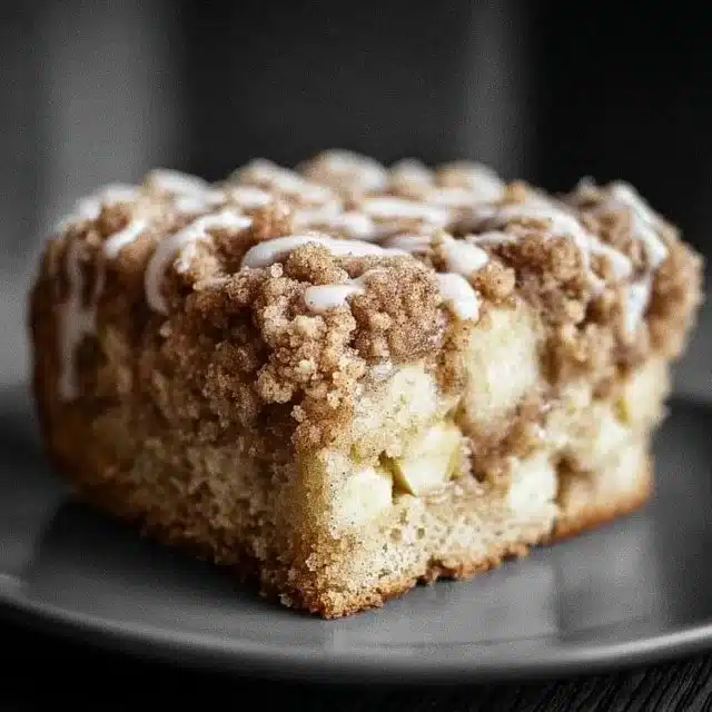 Slice of homemade Apple Crumb Cake with apples and crumb topping