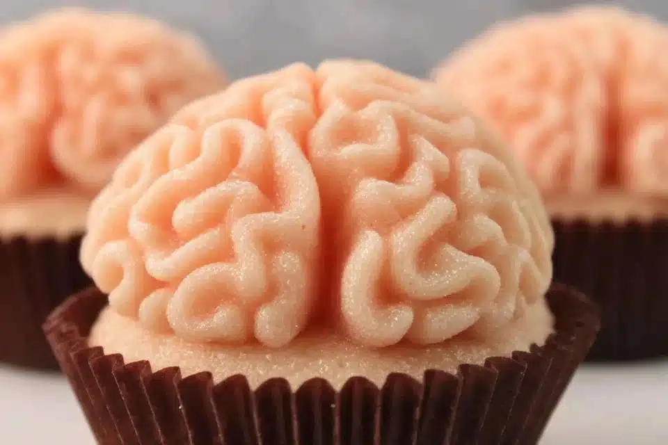 Halloween Brain Cupcakes topped with buttercream frosting for spooky celebrations.
