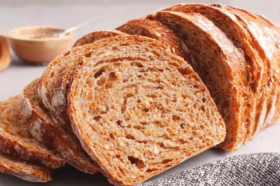 Homemade roasted red pepper bread with garlic and chives on a wooden table