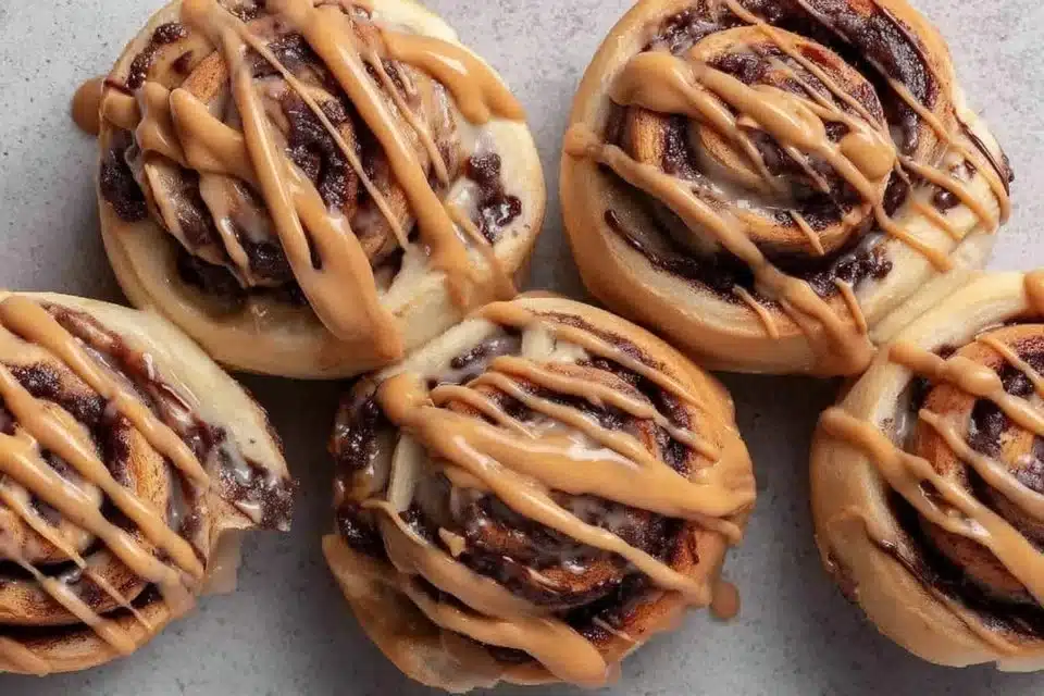 Vegan mocha cinnamon rolls with chocolate espresso glaze on a rustic plate
