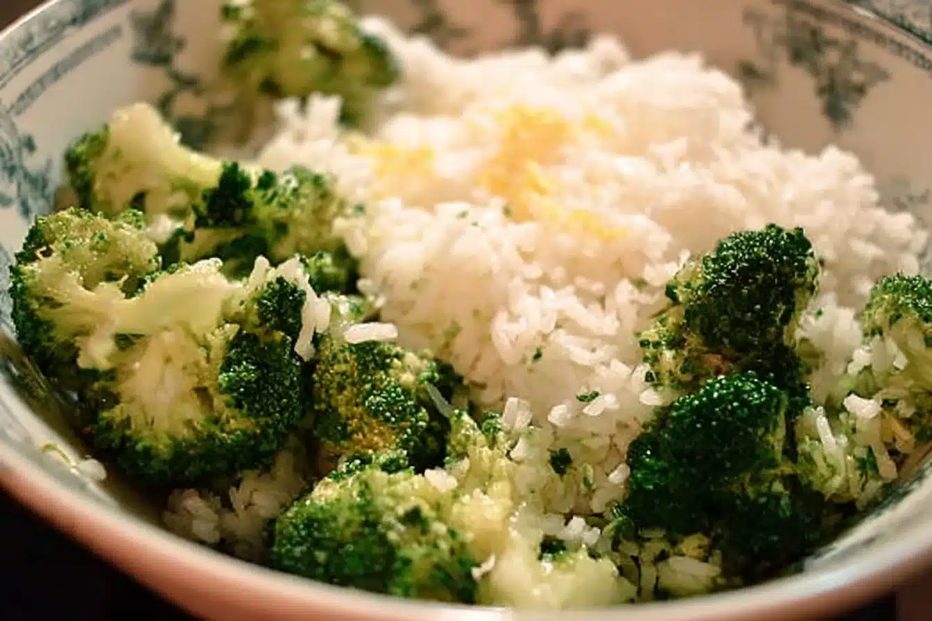 A vibrant dish of Rice and Broccoli garnished with herbs and spices.