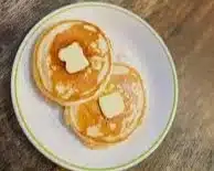 Sausage Dipped Pancakes Delight 3 Plate of sausage dipped pancakes with syrup, a delightful breakfast treat