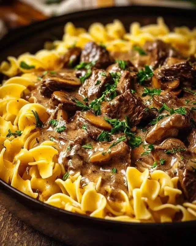Delicious Beef Stroganoff with Egg Noodles served in a creamy sauce.