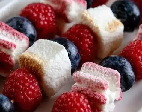 Festive patriotic fruit skewers with red, white, and blue fruits