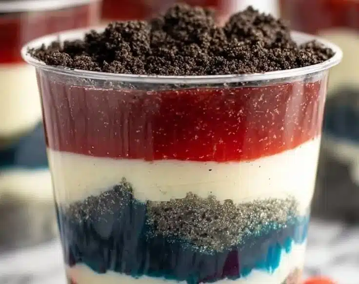 Red, White, and Blue Dirt Cups layered with whipped cream and berries