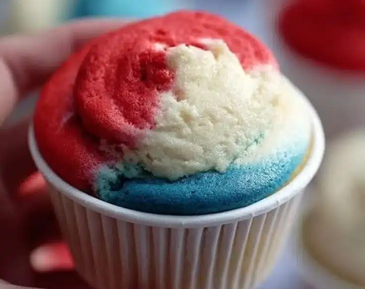Colorful snow cone cupcakes topped with vibrant frosting representing different flavors.