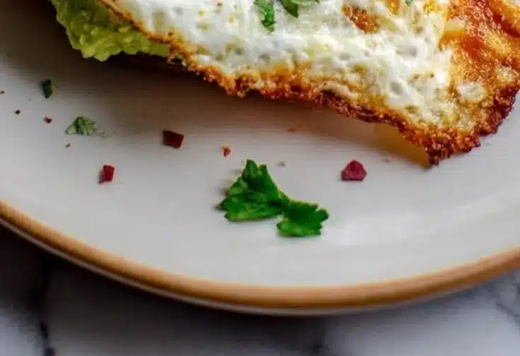 Baked sweet potato toast topped with avocado and egg
